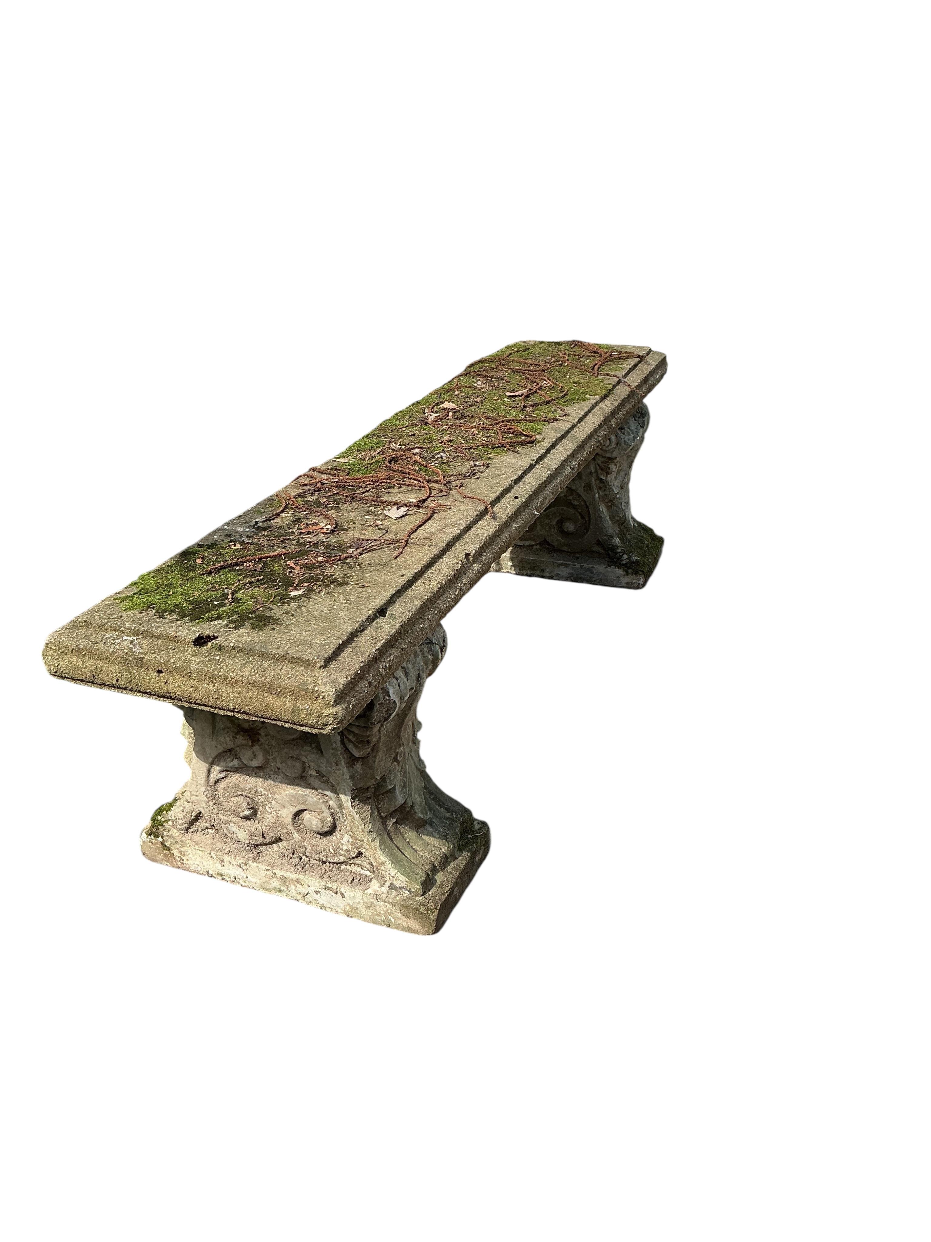 A rectangular reconstituted stone garden bench, width 142cm, height 42cm